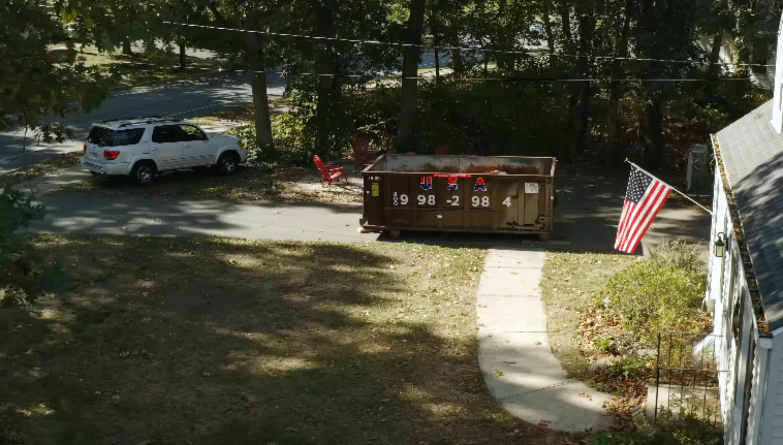 Red roll-off dumpster container on concrete pad — construction and renovation dumpster rental serving Owensboro and Daviess County KY